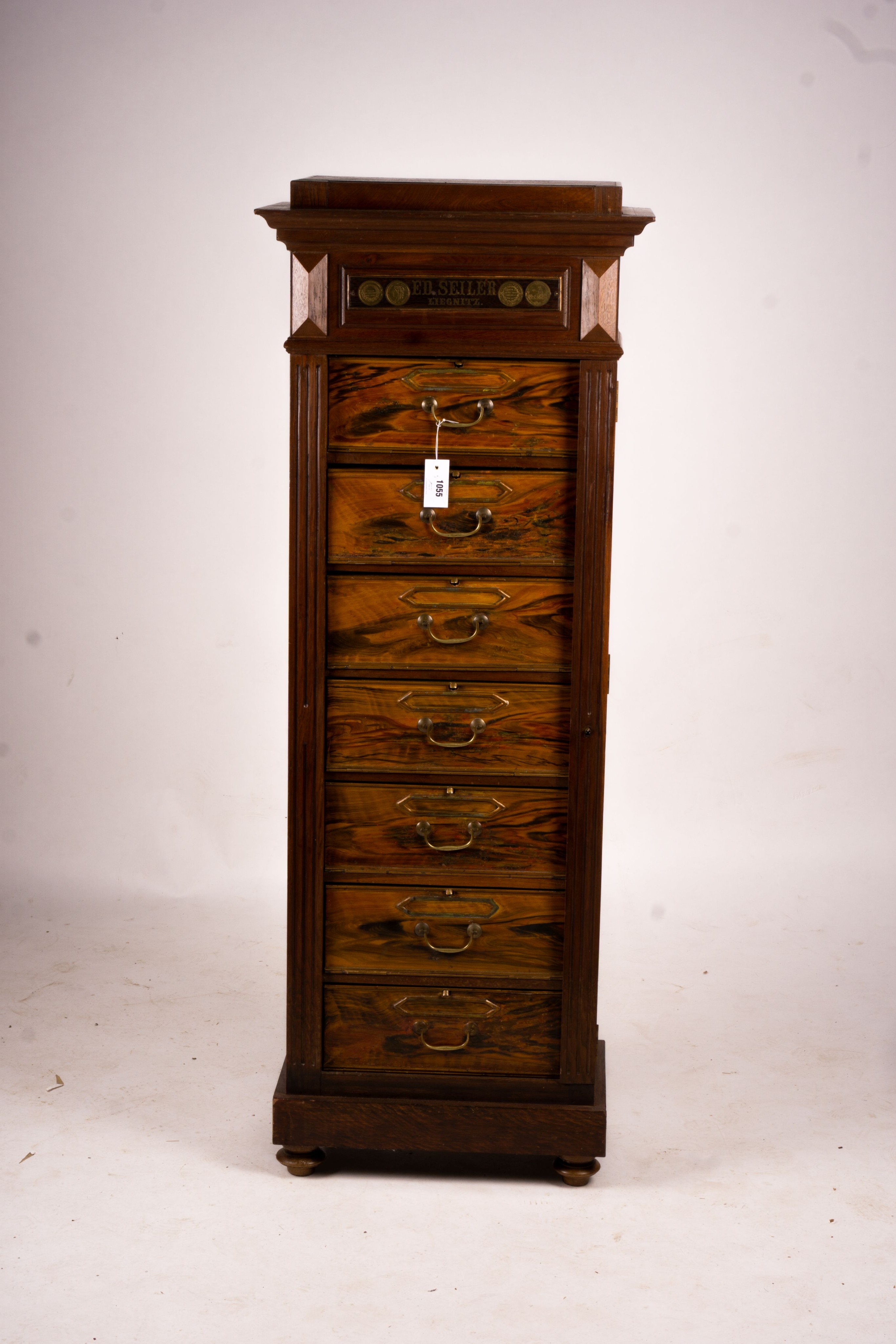 A late 19th / early 20th century oak and simulated walnut shop storage chest / filing cabinet, labelled Ed Seiler, width 57cm, depth 34cm, height 152cm